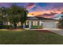 Charming single Gathering home with a well-manicured lawn under a colorful evening sky at 4731 Se 32Nd St, Ocala, FL 34480