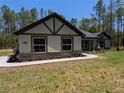 Charming home with stone accents and a landscaped walkway leading to the front door at 8303 Sw 127 Ave, Dunnellon, FL 34432