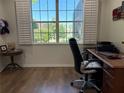 Bright home office with large windows and plantation shutters, offering a comfortable workspace at 8504 Sw 84Th Loop, Ocala, FL 34481