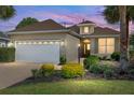 Charming single-Gathering home featuring a two-car garage, mature landscaping, and a well-maintained lawn at 8669 Sw 88Th Loop, Ocala, FL 34481