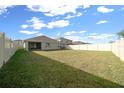 Spacious backyard enclosed by a white fence, offering a blank canvas for outdoor activities and entertainment at 8920 Sw 49Th Cir, Ocala, FL 34476