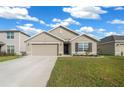 Charming single Gathering home featuring a well-manicured front yard, neutral toned stucco, and a two car garage at 8920 Sw 49Th Cir, Ocala, FL 34476