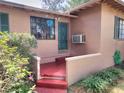The front porch shows a painted red floor and a dark-green door at 1034 Ne 11Th St, Ocala, FL 34470