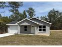 Charming single-story home with a well-manicured lawn and attached two-car garage at 107 Sw Alvarez Rd, Dunnellon, FL 34431