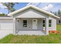 Inviting home exterior with a covered front porch, perfect for relaxing outdoors at 107 Sw Alvarez Rd, Dunnellon, FL 34431