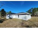 Back view of this delightful home, showcasing its well-manicured lot at 107 Sw Alvarez Rd, Dunnellon, FL 34431