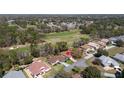 Aerial view of a home on a golf course with mature trees, and well-maintained landscaping at 11587 Sw 72Nd Cir, Ocala, FL 34476
