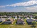 Neighborhood view featuring manicured lawns, screened-in pools, and beautiful landscaping at 13128 Se 97Th Terrace Rd, Summerfield, FL 34491