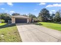 Lovely one-story home with a large driveway and an attached two-car garage at 14059 Sw 47Th Ave, Ocala, FL 34473
