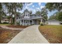 View of charming two-story home, long driveway, with detached garage in backyard at 1628 Se 29Th Ter, Ocala, FL 34471
