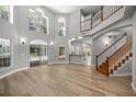 Spacious living area with wood floors, high ceilings, and abundant natural light, with staircase and backyard access at 1628 Se 29Th Ter, Ocala, FL 34471