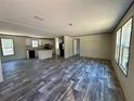 Spacious living room with modern flooring, leading into a bright kitchen with an island at 1921 Nw 120Th Ave, Ocala, FL 34482