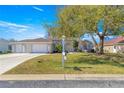 Charming single-story home with a three-car garage, mature landscaping, and a well-maintained lawn at 1956 Nw 50Th Cir, Ocala, FL 34482