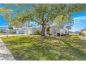 Beautiful single-story home with mature trees, well-manicured lawn, and an inviting curb appeal at 1956 Nw 50Th Cir, Ocala, FL 34482