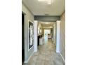 Bright, spacious hallway leads to living area with tiled floors and contemporary decor at 4241 Sw 62Nd Loop, Ocala, FL 34474