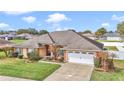 Beautiful exterior view of a home featuring well-manicured lawn, attached garage, and elegant landscaping at 4839 Sw 63Rd St, Ocala, FL 34474