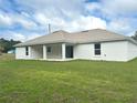 An expansive backyard featuring a covered patio, seamlessly merging indoor and outdoor living at 5646 Sw 129Th Place Rd, Ocala, FL 34473
