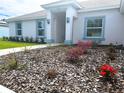 Close up of the home's front yard and manicured landscaping with mulch and blooming flowers at 5646 Sw 129Th Place Rd, Ocala, FL 34473