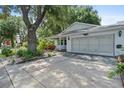 Exterior view of home showcasing driveway and lovely landscaping at 8430 Sw 90Th Ln # A, Ocala, FL 34481