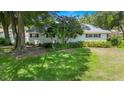 A quaint home featuring a well-manicured front yard and mature trees at 8430 Sw 90Th Ln # A, Ocala, FL 34481