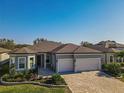 Beautiful single-story home with brick driveway, manicured lawn, and attached two-car garage at 8843 Sw 57Th Place Rd, Ocala, FL 34481