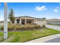 Well-maintained home with a three-car garage, front porch, and drought-tolerant landscaping at 10314 Sw 96Th Loop, Ocala, FL 34481