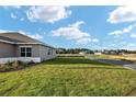 View of the side of this single-story home with a freshly cut lawn in a quiet residential neighborhood at 10557 Sw 98Th Ln, Ocala, FL 34481