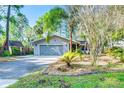 Charming single-story home featuring a well-maintained front yard and two-car garage at 11720 Cherokee Cir, Dunnellon, FL 34431