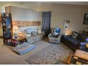 Cozy living room with couches, recliner, carpet and a large area rug at 11860 Nw 18Th Pl, Ocala, FL 34482