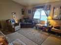 Inviting living room with comfortable seating, decor, and natural light at 11860 Nw 18Th Pl, Ocala, FL 34482