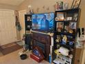 Comfortable living area with fireplace, TV, and built-in shelving at 11860 Nw 18Th Pl, Ocala, FL 34482