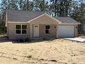 Charming single-story home boasts a well-maintained lawn and a neutral-colored stucco exterior at 127 Sw Alvarez Rd, Dunnellon, FL 34431