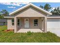 Inviting one-story home featuring a charming front porch and attached one car garage at 127 Sw Alvarez Rd, Dunnellon, FL 34431