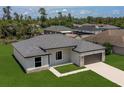 Low aerial view of this charming one-story home, highlighting the manicured yard and neighborhood at 3085 Sw 131St Place Rd, Ocala, FL 34473