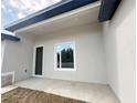 Covered lanai featuring neutral siding, and a sliding glass window to the backyard at 3085 Sw 131St Place Rd, Ocala, FL 34473