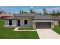 Well-manicured front yard and stone accents highlight the exterior of this charming one-story home at 3085 Sw 131St Place Rd, Ocala, FL 34473