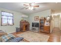 Cozy living room with vintage furnishings, hardwood floors, and ample natural light at 324 S Highland St, Bushnell, FL 33513