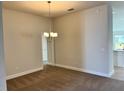 Cozy dining area featuring a chandelier and seamless transition to the kitchen at 4381 Sw 90Th Pl, Ocala, FL 34476