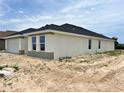 Contemporary-style home with neutral stucco, a dark roof, and well-placed windows, currently under construction at 4381 Sw 90Th Pl, Ocala, FL 34476