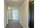 Inviting hallway featuring neutral paint, carpet and views of the home's open layout at 4381 Sw 90Th Pl, Ocala, FL 34476