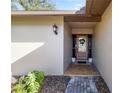 Welcoming front entrance with a decorative door, stylish lighting, and neatly landscaped surroundings at 4425 Se 2Nd Pl, Ocala, FL 34471
