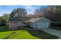 Charming single-story home with well-maintained lawn and attached two-car garage at 53 Juniper Trail Cir, Ocala, FL 34480