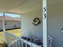 Inviting front porch with seating, perfect for enjoying quiet moments at 53 Juniper Trail Cir, Ocala, FL 34480