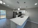 Modern kitchen featuring stainless steel appliances and a stylish breakfast bar at 6620 Se 108Th Ln, Belleview, FL 34420