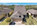 A high angle view of the house showcases the roof, landscaping and neighborhood at 7234 Sw 91St Ct, Ocala, FL 34481