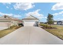Charming single-Gathering home featuring a two-car garage and well-manicured lawn and landscaping at 7935 Sw 89Th Ter, Ocala, FL 34481