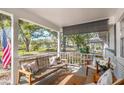 Charming front porch with comfortable seating, stylish decor, and a serene view of the neighborhood at 8665 Sw 94Th Ln # C, Ocala, FL 34481