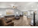Open-concept living room with vaulted ceiling, wood-look floors, and a sliding glass door leading to the outdoors at 13458 Sw 113Th Pl, Dunnellon, FL 34432