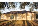 Rear of the house featuring sliding glass doors and several windows for ample natural light at 13700 Sw 48Th Ct, Ocala, FL 34473