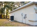 View of the home's exterior featuring the AC unit, electrical box, and well-maintained siding at 13700 Sw 48Th Ct, Ocala, FL 34473
